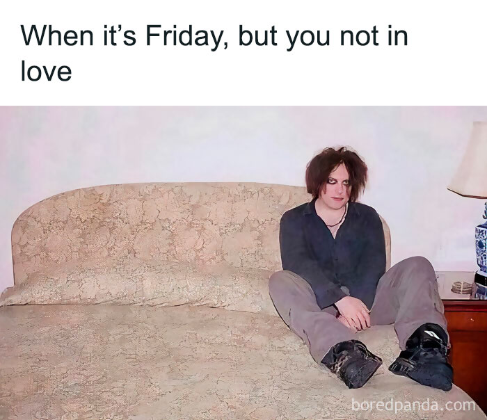 Person sitting on a bed with a melancholic expression, capturing the feeling of not being in love on a Friday. Happy Friday meme.