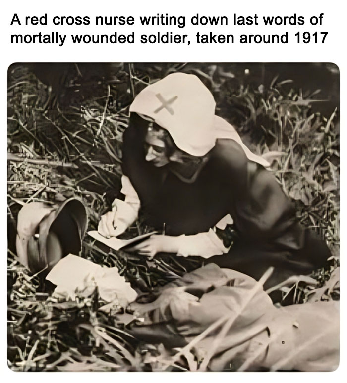 Red cross nurse writing last words of wounded soldier on battlefield, historical moment included in daily dose of history facts.
