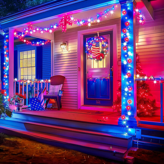 Front porch decorated with red, white, and blue lights and wreath, perfect for backyard July 4th parties celebration.
