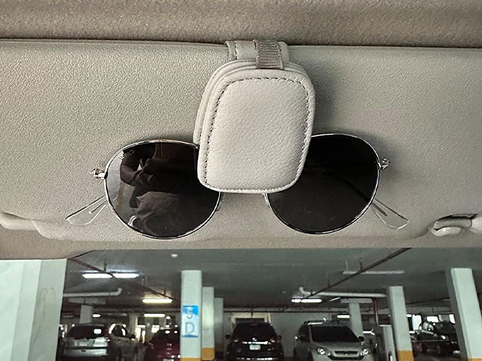 Sunglasses clipped to a car visor, showcasing a handy car item.