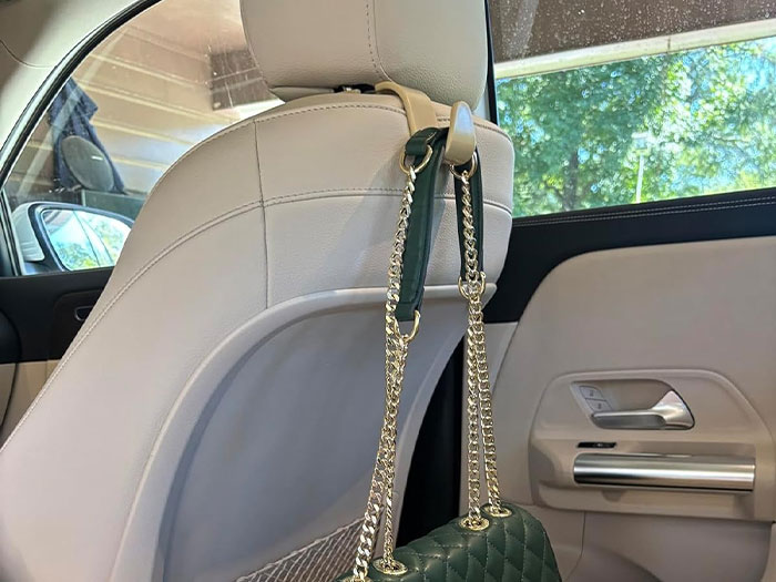 Car with multiple hooks holding bags and items, showcasing clever car organization ideas.