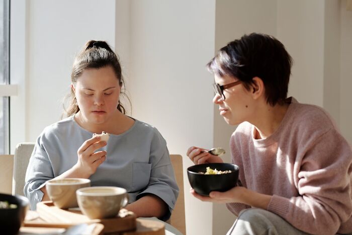 Two women enjoying a meal together, representing connections between people in their 40s 50s and 60s with Gen Z.