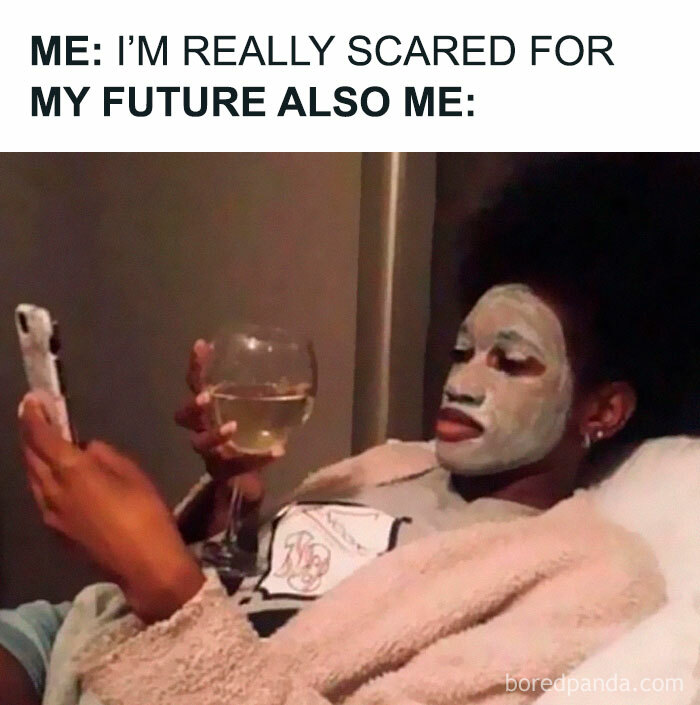 Person procrastinating with a face mask on, holding a phone and drink, embodying relatable memes about procrastination.