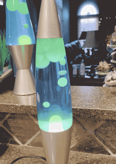 Lava lamps with glowing green and blue wax bubbles, showcasing one of the year's most amazing discoveries for spreading joy.