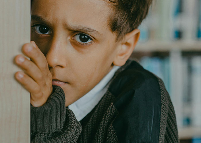 Close-up of a child looking anxious and withdrawn, illustrating feelings tied to bad parenting concerns.