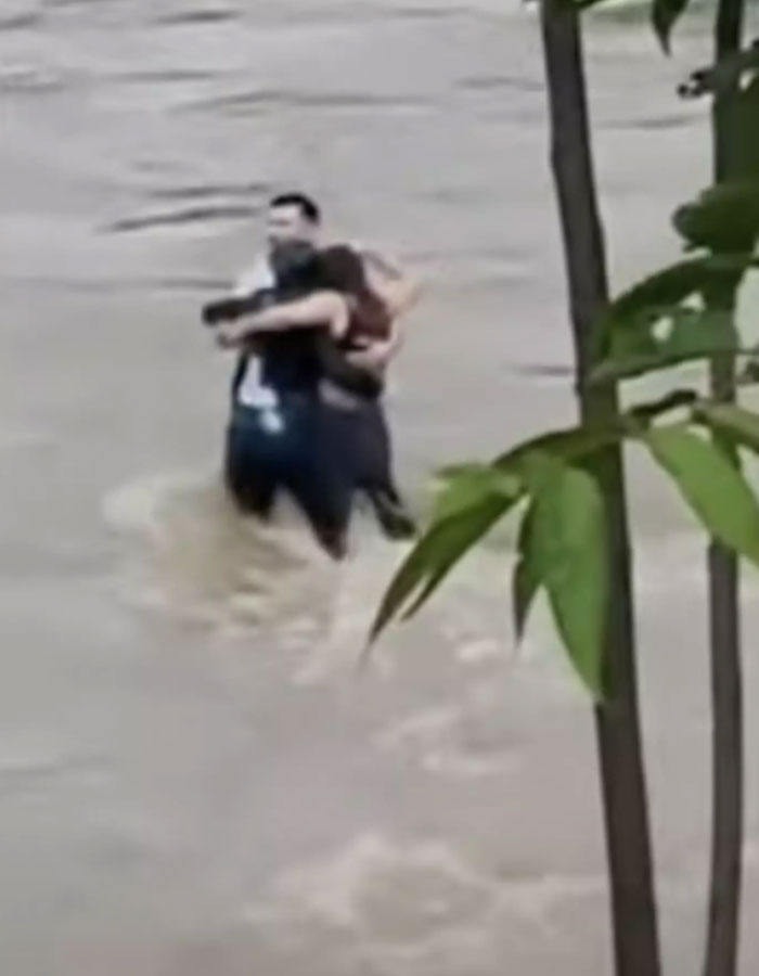 Footage Shows Three Friends In Final Hug Moments Before Being Swept Away In Flood