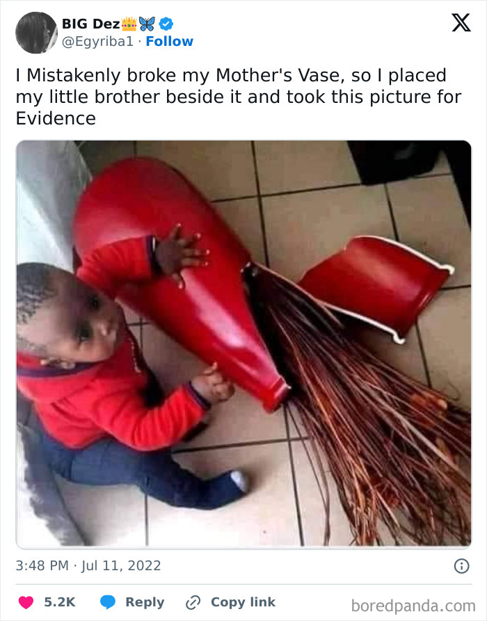 A baby in a red outfit sits next to a broken red vase, looking curious, embodying the humor of random memes.