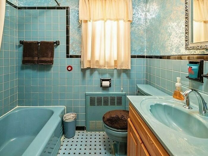 1955 Traditional In Staten Island, NY. Vintage Blue And Black Tile Combo Here With Probably The Wrong Choice Of Wallpaper And A Vanity That Slaps You In The Face. If Only That Wallpaper Provided Some Contrast. I’m Wondering What Color Would Work Here. I’m Leaning Towards A Black With Some Design Features (Shapes Or Floral), But Would That Be Too Dark? A Replacement Vanity Also Proves To Be A Tough Choice, What Should We Do Here Team?