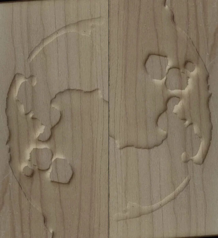 Wooden surface with an abstract, confusing carved design that might require a double take.