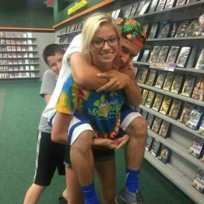 Three people creating a confusing optical illusion in a store aisle, requiring a second look.