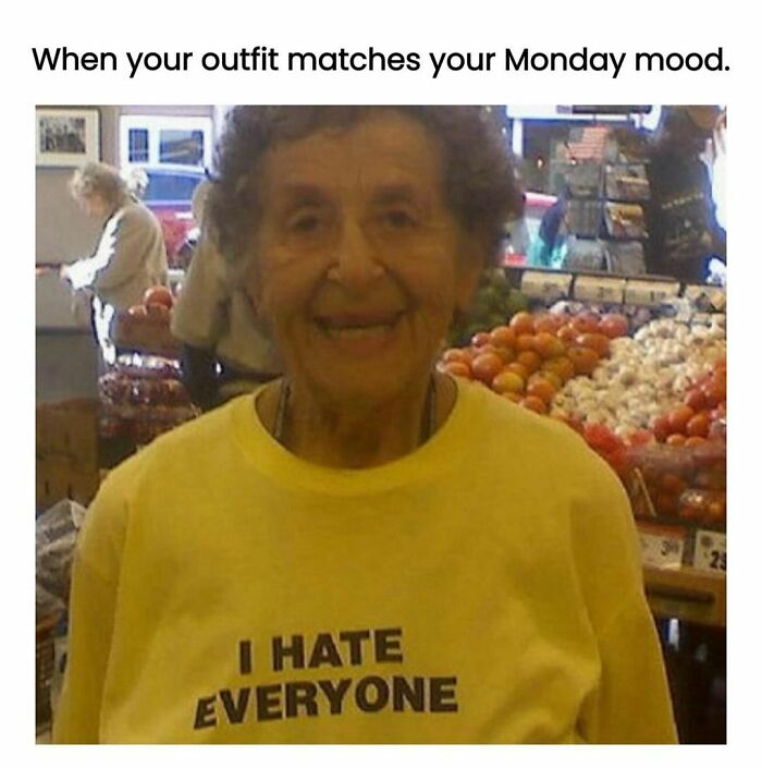 Elderly woman in a store wearing a yellow shirt with the text "I hate everyone," capturing a funny meme mood.