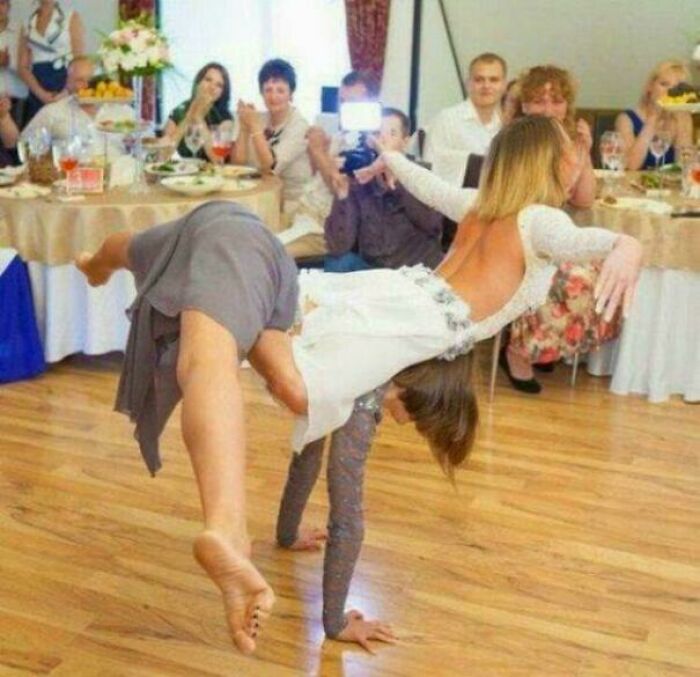 Confusing pic of a wedding dance illusion with bridesmaids intertwined, creating a puzzling scene requiring a double take.