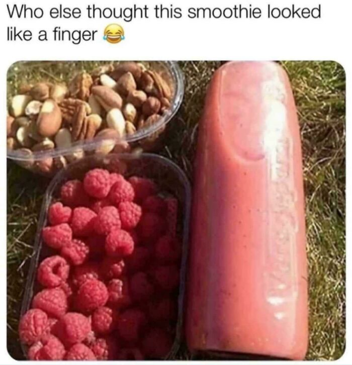 Smoothie bottle resembling a finger with nuts and raspberries, creating a seriously confusing optical illusion.