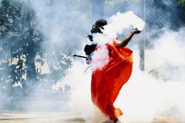 A Monk Wearing A Gas Mask Throwing Tear Gas Back At The Police During Protests In Sri Lanka 🇱🇰