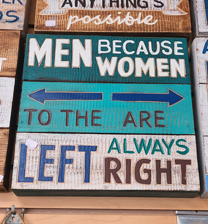 Humorous wooden sign fail with mixed messages and directional arrows.