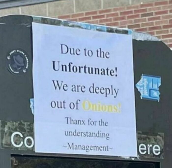 Sign on a window apologizing for being out of onions, a random photo example for processing challenges.