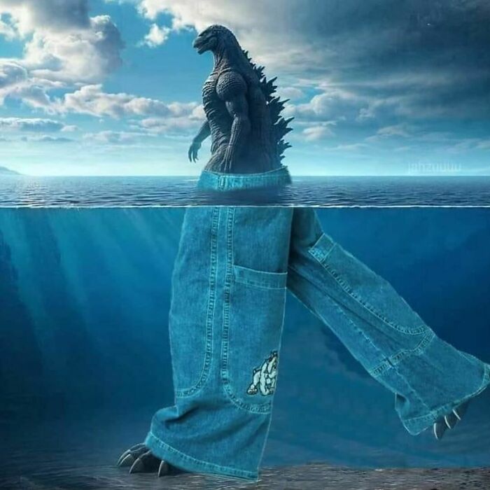 Godzilla standing in water wearing oversized jeans, a humorous twist from Pics That Go Hard collection.