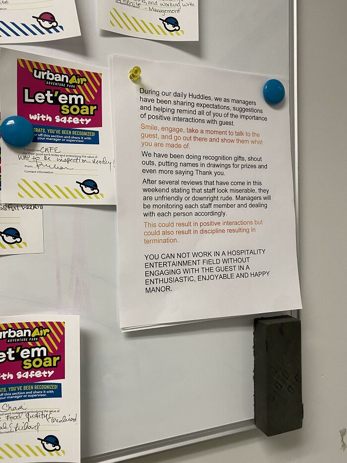 Workplace notice pinned on board about employee behavior and positive interactions, highlighting ridiculous capitalism demands.