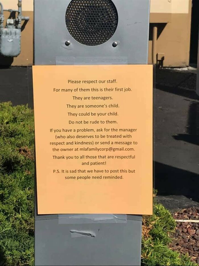 Sign taped to speaker urging respect for teenage staff, highlighting how ridiculous capitalism is getting in customer treatment.