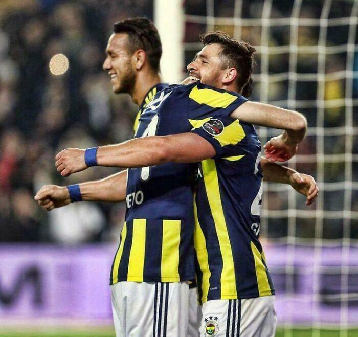 Footballers embracing, creating a confusing optical illusion during a match.