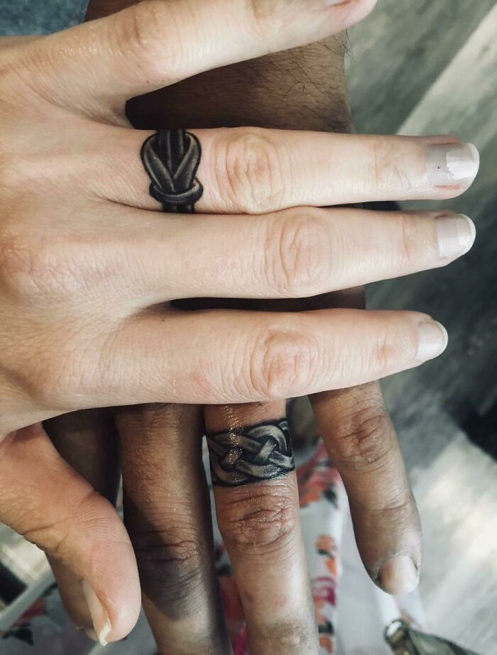 Unique ring-like tattoos on fingers showcasing intricate tattoo designs.