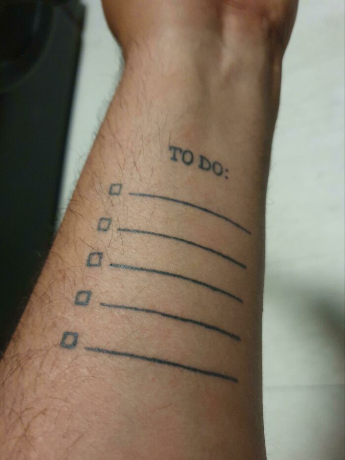 Tattoo of a to-do list with checkboxes on a forearm, showcasing creative tattoo designs.