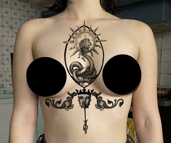 A detailed chest tattoo featuring mythical creatures and ornate design, showcasing tattoo artists' exceptional creativity.