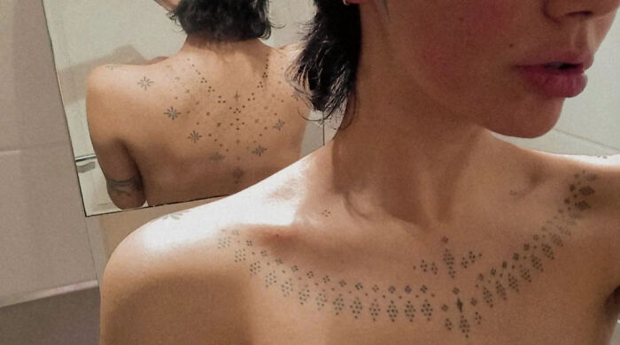 Elegant geometric tattoos on a woman's back and collarbone, showcasing intricate designs by talented tattoo artists.