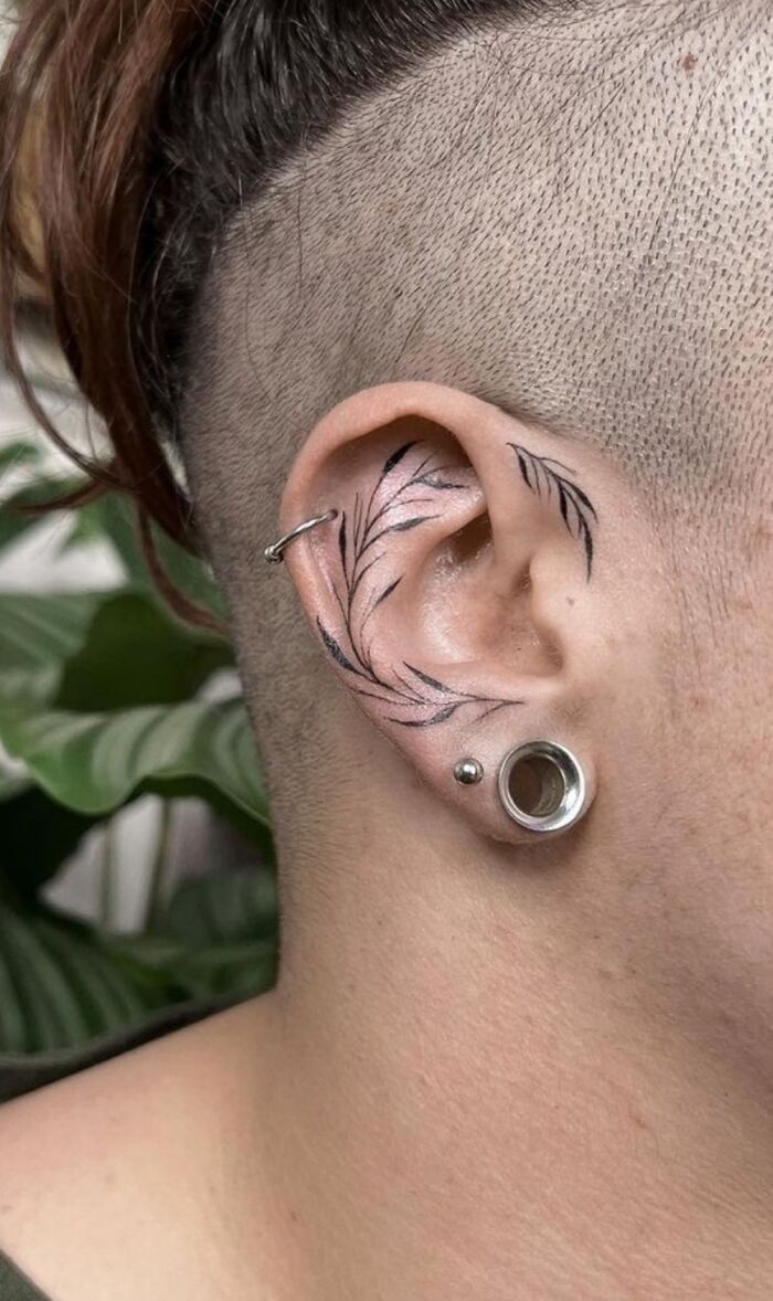 Intricate ear tattoo design showcasing tattoo artists' creativity and skill.