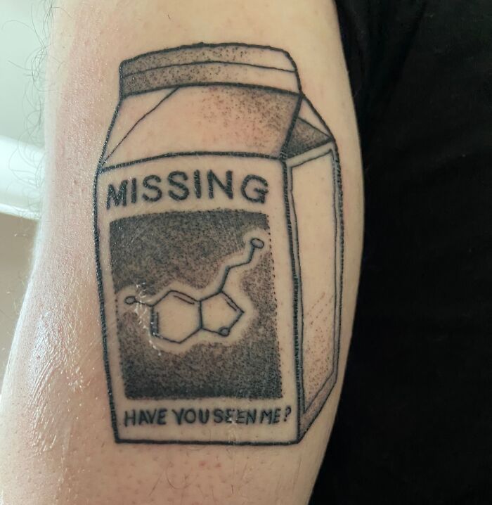 Creative tattoo of a "missing" milk carton featuring a chemical structure, showcasing artistic design skills.