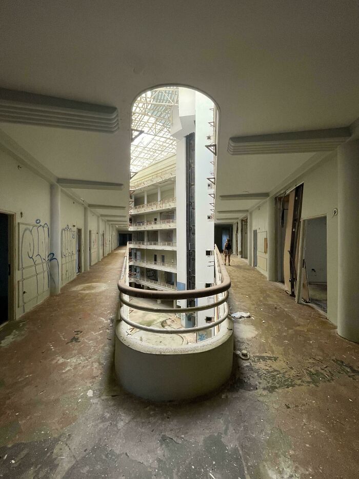 Abandoned corridor with confusing architecture, requiring a double take to understand its structure.