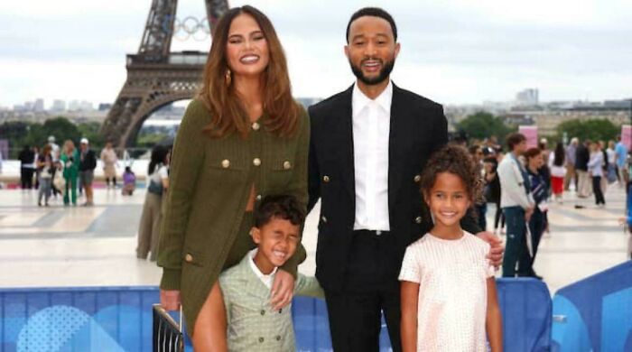 A family poses in front of the Eiffel Tower, showcasing a seriously confusing image with a lighthearted vibe.