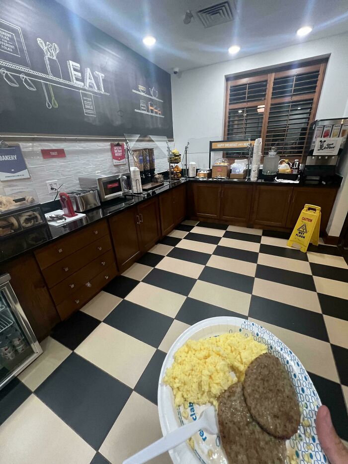 Person with breakfast plate, blending into a self-serve hotel buffet setting to cheat the system.