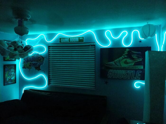 Neon-lit game room with decor and "Hustle" artwork, revealing contractor secrets.