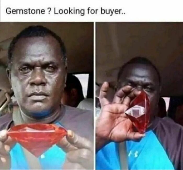 Man holding a large red gemstone, looking for a buyer, in a humorous setting.