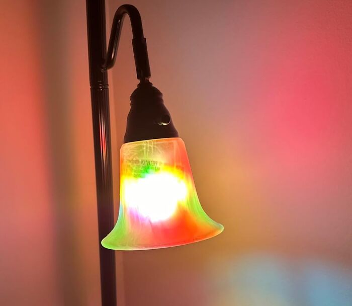 Colorful glowing lamp with a frosted glass shade illuminating a room, one of the weirdly wonderful finds.