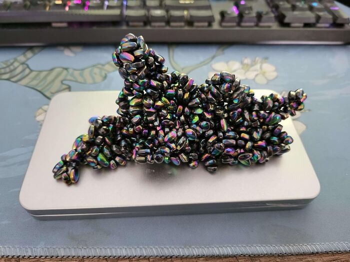 Colorful clustered beads on a metallic surface, catching attention with their unique arrangement and iridescent hues.