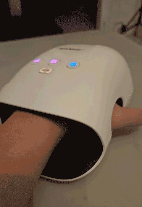 Hand in a white device with glowing buttons, showcasing a weird thing you might not know about.
