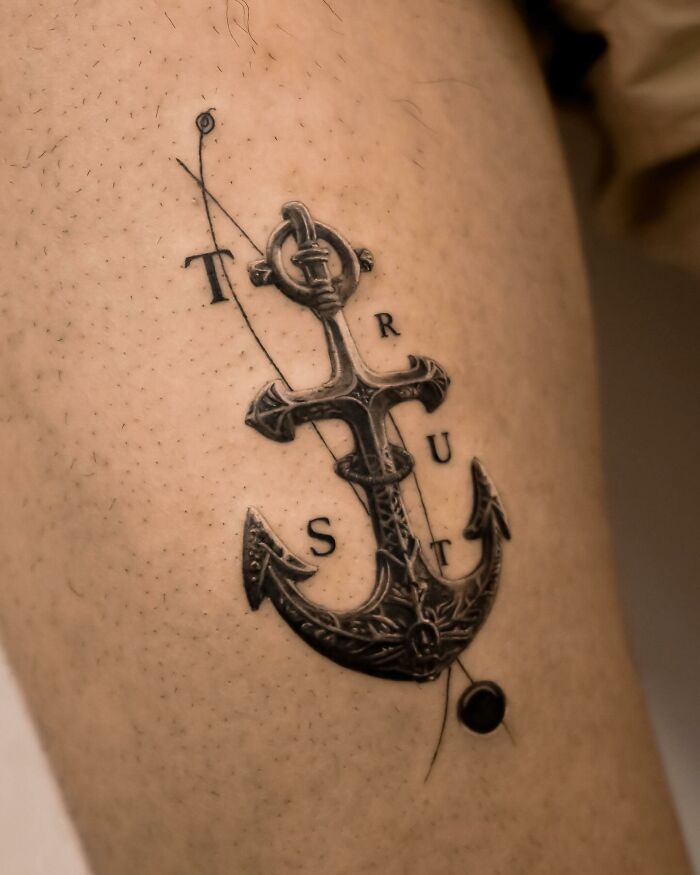 Hyperrealistic tattoo of an anchor with text "TRUST" on skin, resembling a detailed photograph.