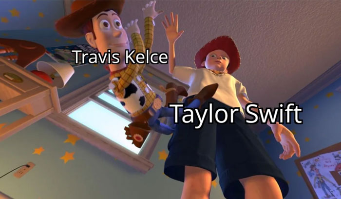 A Taylor Swift meme featuring a scene from an animated movie. The image shows a character labeled "Taylor Swift" holding up a toy character labeled "Travis Kelce." The perspective is from below, looking up at the characters in a playful, dramatic pose.