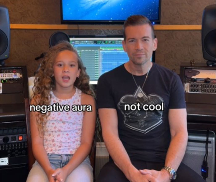 Father learning slang from daughter in a music studio setting, both displaying expressions.