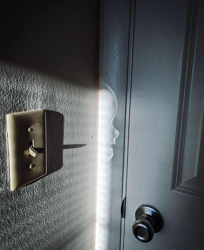 The Light Reflected A Baby's Head On The Door