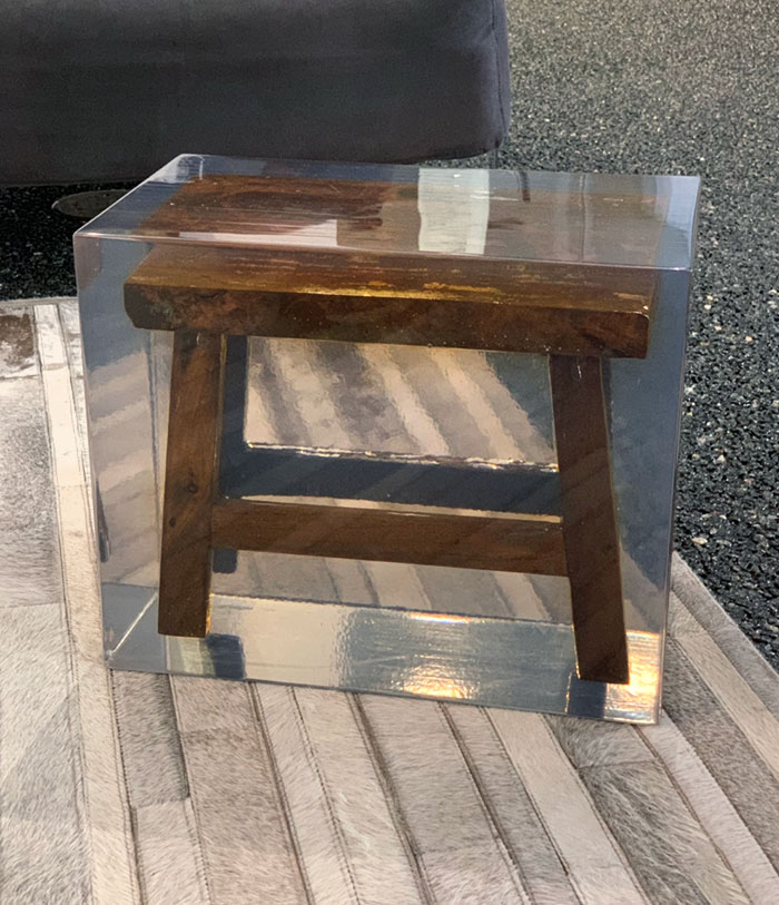 This Lobby’s "Modern" Clear Footstool Contains An Old Rustic Footstool