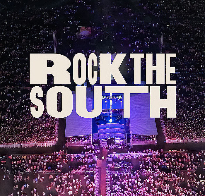 Aerial view of a concert with large crowd and stage, "Rock the South" logo prominently displayed.