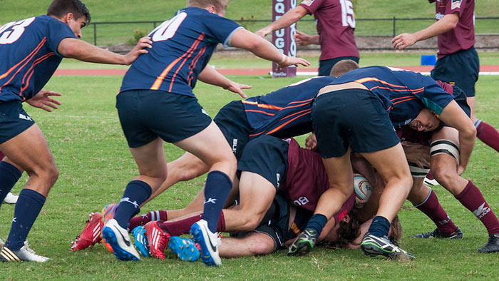 Rugby players from different teams in a dynamic match, illustrating diverse sports stereotypes about people’s home countries.