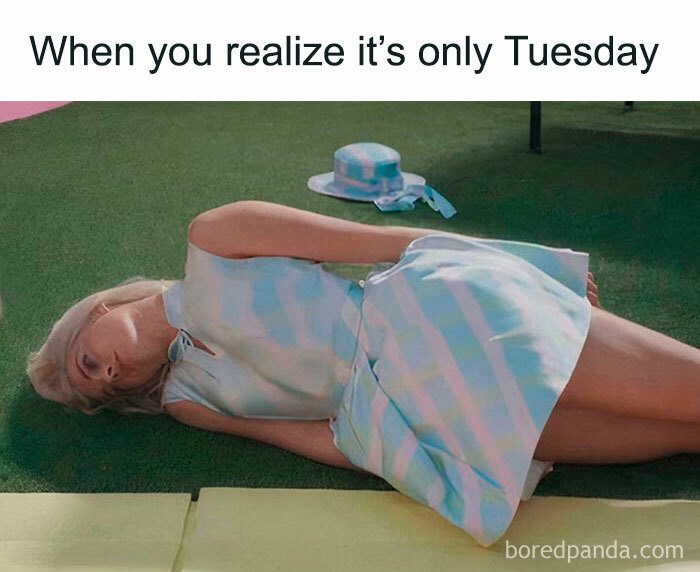 Woman in pastel dress lying on grass, embodying a humorous Tuesday meme.