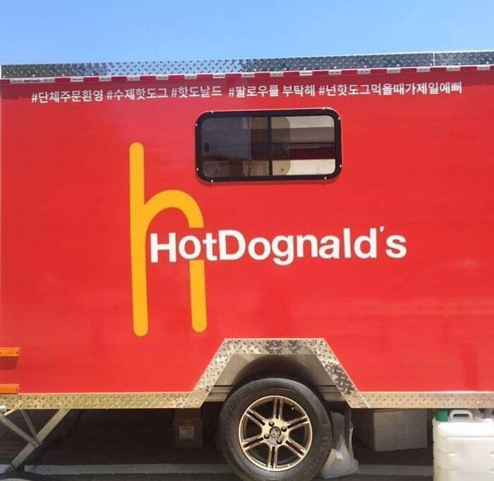 Red food truck with a hilariously bad rip-off brand name HotDognald's in yellow and white lettering on the side.
