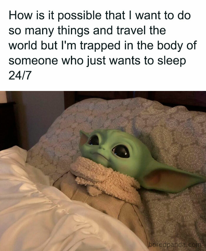 A vacation meme featuring a plush Baby Yoda (Grogu) from "The Mandalorian" lying in bed, wrapped in a blanket and looking up with wide eyes. The text above the image reads, "How is it possible that I want to do so many things and travel the world but I'm trapped in the body of someone who just wants to sleep 24/7." The meme humorously contrasts the desire for adventure with the reality of wanting to rest.