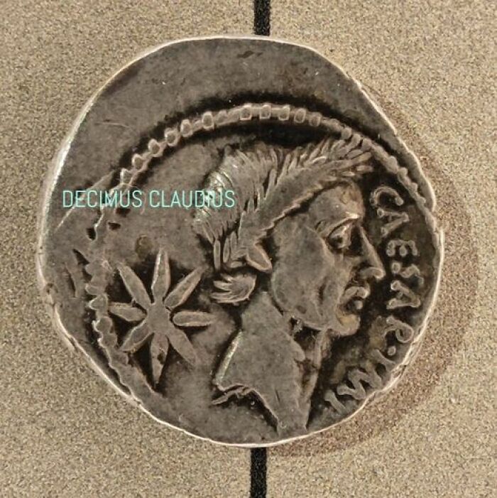 A Roman Denarius Of Julius Caesar, After Whom The Month Of July Is Named, As Imperator In Front Of An Eight Rayed Star