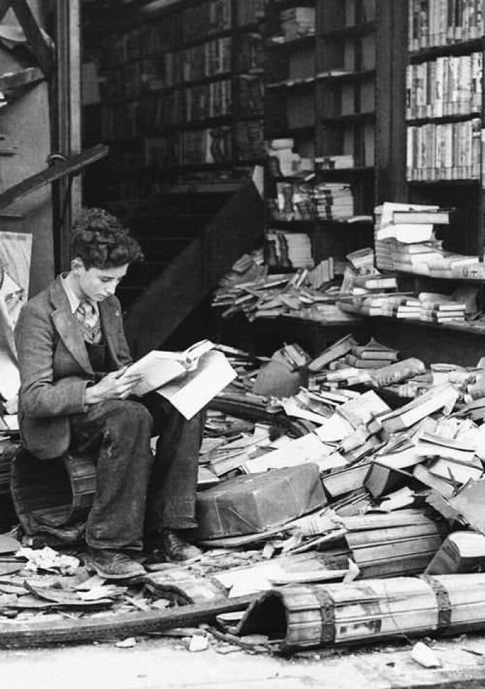 A Boy Sits Reading In A Bombed Bookstore, London, 1940